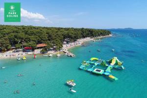 an aerial view of a beach with a water slide at Mobile home JOY in Biograd na Moru