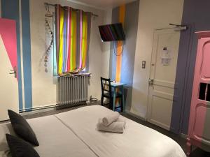 a bedroom with a bed with a towel on it at Logis Hotel Restaurant Le Grand Puech in Mimet