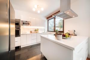 a kitchen with white cabinets and a counter top at Porsche Villa mit Garten und Garage in Bestlage von Döbling in Wien in Vienna