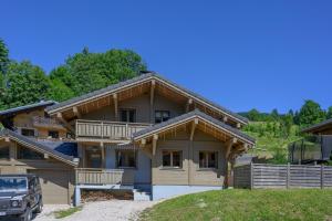 a large wooden house with a gambrel at Chalet Talini in Les Gets