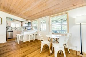 a kitchen and dining room with a table and chairs at Cast a Waves - Cute Beach Bungalow - Ocean Views - Walk to the Beach in Galveston