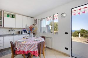 a kitchen with a table with a table cloth on it at casa vacanza Sanaa in Civezza