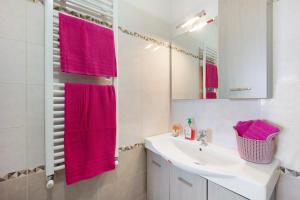 a bathroom with a sink and a red towel at casa vacanza Sanaa in Civezza +12 photos