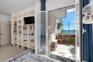 a bedroom with a mirror and a view of the ocean at Casa Nina in Arenzano