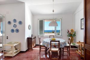 a dining room with a table and chairs and a window at Casa Nina in Arenzano