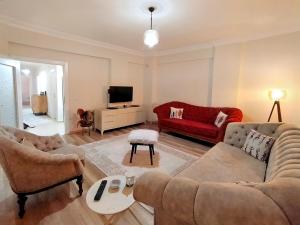 a living room with two couches and a tv at Spacious and Cozy Apartment in Muratpasa Antalya in Antalya