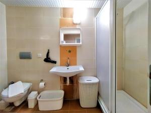 a small bathroom with a sink and a toilet at Spacious and Cozy Apartment in Muratpasa Antalya in Antalya