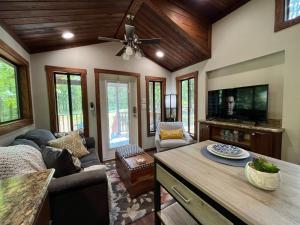 a living room with a couch and a tv at Snuggle Up in Broken Bow