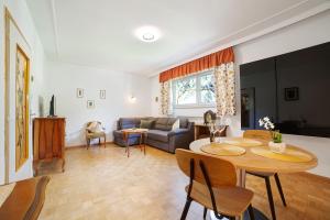 a living room with a table and a couch at Villa Sabine - Renate in Merano