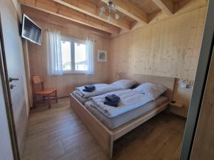a bedroom with a bed in a wooden room at Hubertus in Dietingen