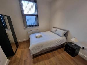 a small bedroom with a bed and a window at Portside Liverpool in Liverpool