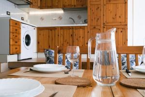 a dining room table with a bottle and glasses on it at Casa Giuly in Crema