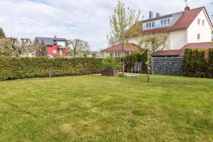 a yard with a green lawn in front of a house at Wiesenblick in Radolfzell am Bodensee