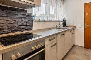 a kitchen with a sink and a stove at Wiesenblick in Radolfzell am Bodensee