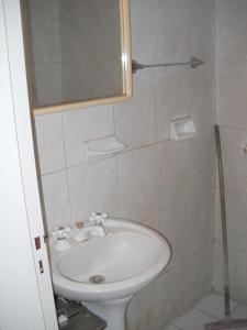 a bathroom with a sink and a mirror at Hotel Aeropuerto Monte Grande in Monte Grande