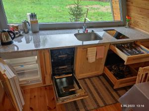 a kitchen with a sink and a counter top at Świronek in Białowieża