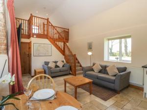 a living room with a staircase and a couch and a table at Sunnyside in Weston-super-Mare