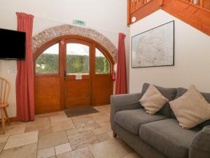 a living room with a couch and a door at Sunnyside in Weston-super-Mare