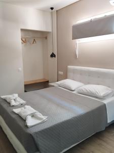 a bedroom with two beds with towels on them at Cavo D' Oro Complex in Kavos
