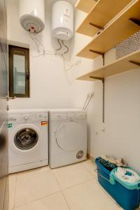 a laundry room with a washer and dryer at Seaside Oasis Your Own Private Getaway in St Julians in St. Julianʼs