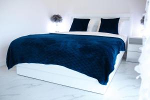 Łóżko lub łóżka w pokoju w obiekcie Apartamenty Scarlet