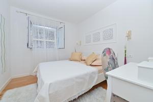 Postel nebo postele na pokoji v ubytování Apartment Đaninovica II