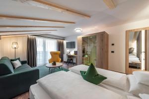 A bed or beds in a room at Vitaurina Royal Hotel