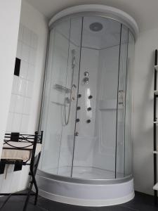 a shower with a glass door in a bathroom at LANDHAUS LAAVE FERIENWOHNUNG 
