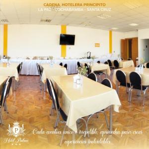 a banquet hall with tables and chairs and a tv at Hotel Palace Capitol in Cochabamba