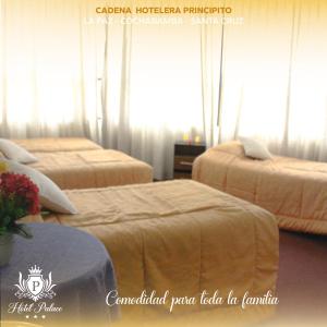 a hotel room with two beds with curtains at Hotel Palace Capitol in Cochabamba