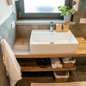 a bathroom with a white sink and a window at B&B Belelì Daramba in Cuneo