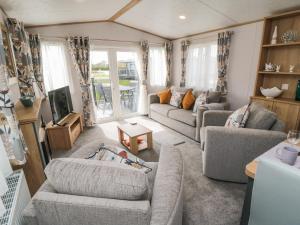 a living room with two couches and a tv at Lodge 7 - Seabreeze Retreat in Bridlington