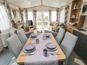 a dining table and chairs in a caravan at Lodge 7 - Seabreeze Retreat in Bridlington