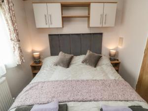 a bedroom with a large bed with two pillows at Lodge 7 - Seabreeze Retreat in Bridlington