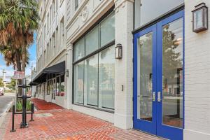 a store front with blue doors on a street at Roami at Motorworks in New Orleans
