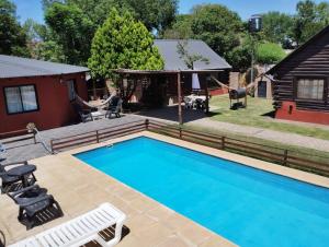 a house with a swimming pool and a yard at Quechua Cabañas Funes in Funes