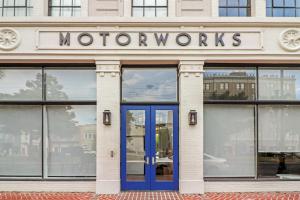 a storefront with a blue door in front of a building at Roami at Motorworks in New Orleans