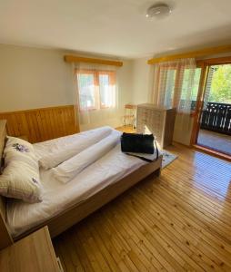 a bedroom with a large bed with a bag on it at Casa de Vacanta Diana Moneasa in Moneasa