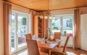 a dining room with a wooden table and chairs at 3 Bedroom Lovely Home In Schortens in Schortens