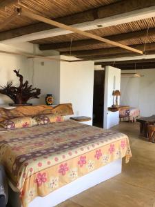 a bedroom with a large bed in a room at Cabañas Las 3 Marias in San Agustinillo