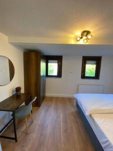 Schlafzimmer mit einem Bett, einem Schreibtisch und einem Bett in der Unterkunft Nisay Home - 3 Room Apartment - Nr3 in Ludwigsburg