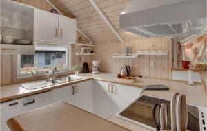 a kitchen with white cabinets and a sink at Gorgeous Home In Slagelse With Sauna in Slagelse
