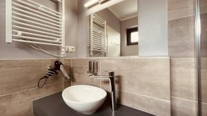 a bathroom with a white sink and a mirror at Apartment Glinde in Hamburg