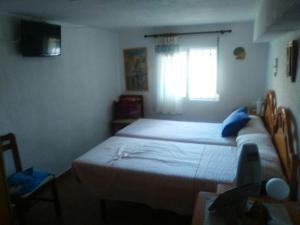 a small bedroom with a bed and a window at La caseta d'Amparo in Catadau