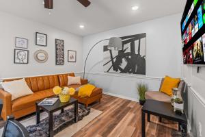 a living room with a couch and a tv at East Passyunk Trendy Apartment in Philadelphia