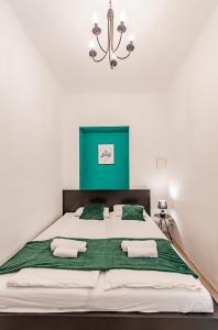 a bedroom with a large bed with a green headboard at My city apartment- Vienna ArtRoom in Vienna