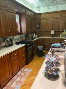 a kitchen with wooden cabinets and a table with plates on it at Queen Anne Bed and Breakfast in Nevada
