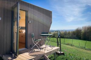 a small house with a table and two chairs on a deck at Sleep Space 1 - Green Tiny Spot Dolmar 