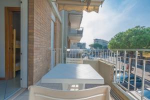 a balcony with a table and chairs on a building at Residence Puerto Del Sol Immobiliare Pacella in Lido di Jesolo