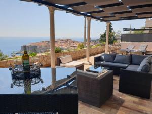 a patio with a bottle of wine on a table at Dubrovniks best views apartment from a spacious terrace in Dubrovnik